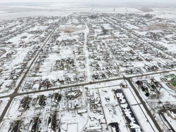 Winter view from the bird's eye view of the village. The streets are covered with snow.