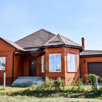 Detached house with a roof made of steel sheets. Roof metal sheets. Modern types of roofing materials.