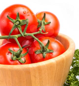 Close up of fresh vine tomatoes in a bowl on the table with a salad