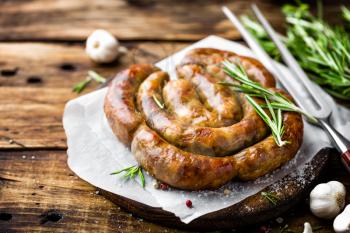 Grilled sausage on dark rustic wooden background
