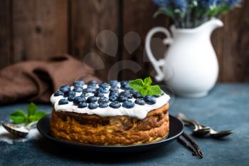 Blueberry cake with fresh berries and whipped cream, cheesecake