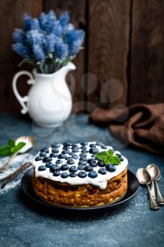 Blueberry cake with fresh berries and whipped cream, cheesecake