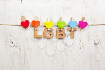  LGBT rainbow and hearts on a white wooden background.LGBT symbol