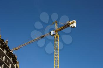 Crane  at construction site against blue sky