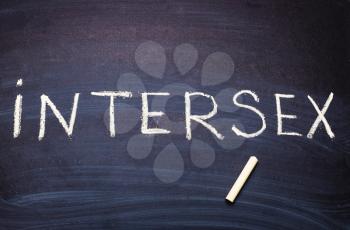 The word intersex is written on the blackboard with chalk.