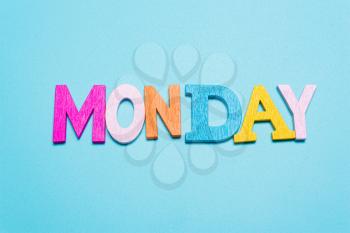 Word MONDAY in multicolored letters on a blue background