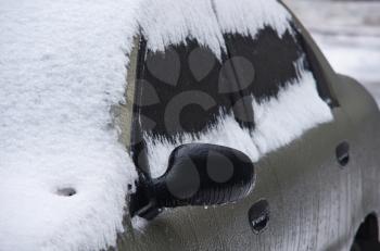 Car under snowdrift. Winter problem scene.