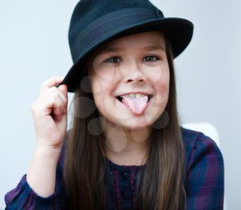 Portrait of a beautiful girl in a black hat
