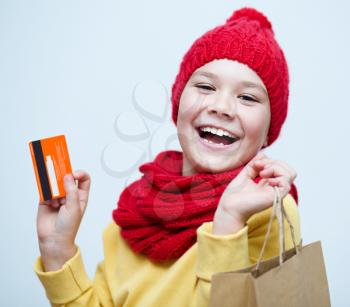Shopping, sale, holiday concept - smiling girl with shopping bags and plastic card
