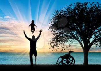 Disabled person with prosthetic leg with small child playing and tree. Concept disabled and family