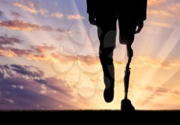 Leg with prosthesis on background sunset. Concept disabled person