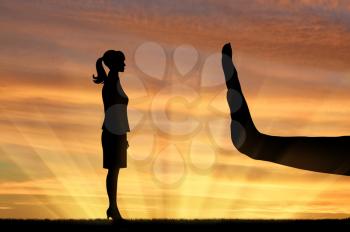 Discrimination and racism concept. Silhouettes of hands stop woman on the sunset background