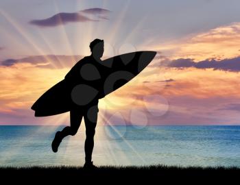 Sports concept. Silhouette of a surfer on the beach at sunset sea background