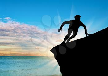 ?oncept of persistence in the business. Silhouette resistant person on a rock on the sea sunset background
