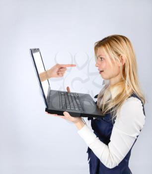  Concept of luck. Surprised woman holding a laptop and hand