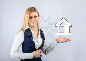 Real estate concept. Business woman holding a house icon
