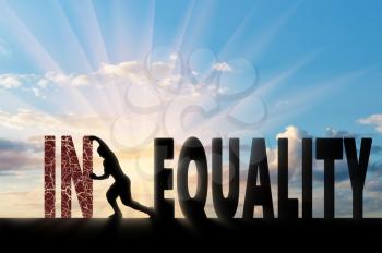 Silhouette of a man pushing a word inequality, achieving equality. Social inequality concept
