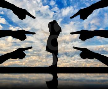 Peers' hands show with their fingers a lonely, frightened child girl who is crying. Conceptual image of bullying children