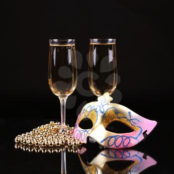 Champagne.New Year's Eve.Celebration. Female carnival mask with glass of champagne
