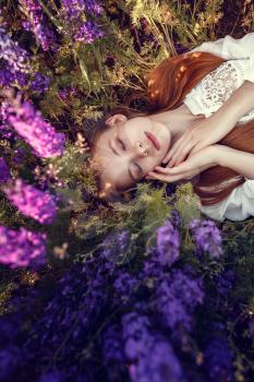 beautiful woman on purple background. woman with purple flowers