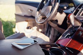 smart phone phone on the car seat dashboard. Lifestyles photo in car. Different views. Without hand, phone.