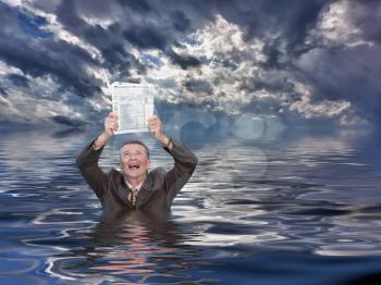 Conceptual image of senior businessman in suit up to waist in deep water worried about completing his taxes on time and holding IRS form 1040. Stormy clouds behind reflect in the ocean.