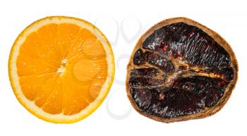 Two isolated oranges cut out against a white background. One orange is new and juicy the other is dried and used as a Christmas aromatic  decoration