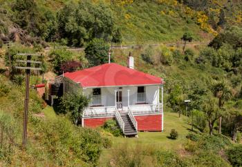 Railway track of Taieri Gorge tourist railway passes Parera station masters house on its journey up the valley