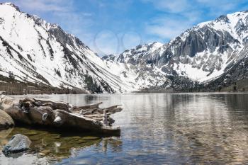 Reflection of snow covered mountains in picturesque Convict Lake in Sierra Nevada California