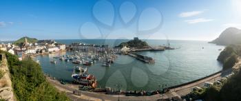 ILFRACOMBE, DEVON UK - JULY 24:  Harbor at sunrise on 24 July 2017 in Ilfracombe, UK. The Damien Hirst statue Verity was erected in 2012