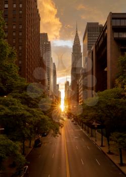 Sun setting along the length of 42nd street in New York city known as Manhattanhenge