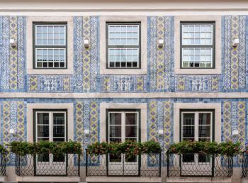 Decorative ceramic tiles on a large house with balconies in downtown Lisbon, Portugal