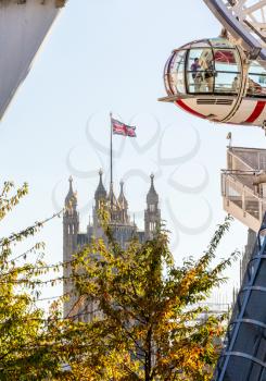 LONDON, UK - OCTOBER 1, 2015: Detail of London Eye  on South Bank of River Thames with Houses of Parliament in London England
