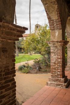 Old brick arches around the cloisters of the Mission at San Juan Capistrano, California