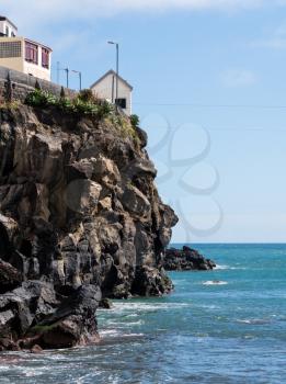 Cliffs by the bay and beach at Camara de Lobos on island of Madiera