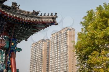 Roof of ancient Confucian Temple surrounded by apartment blocks