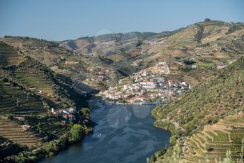 Village of Pinhao on bend in river among the hillsides of the Douro valley in Portugal