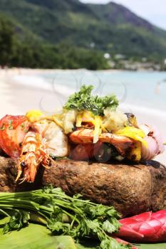 Fried lobster with vegetables and seafood. Cooking seafood in the open air.