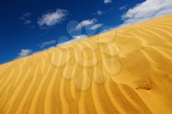 Desert concept, sand dune and blue sky