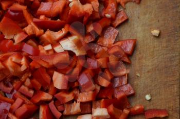 Pepper. Capsicum annuum. Slices of red pepper. On a cutting board. Kitchen. Cooking food. Delicious. Horizontal photo