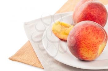 Ripe juicy peach on a white plate