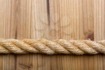 rough rope on a simple wooden light brown background