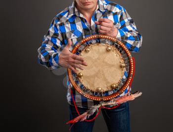 The man plays the tambourine. According to legends, every system administrator, when something breaks down in the server room, must perform a magic ritual using a shaman tambourine.