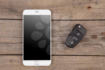 Car security concept - key with remote alarm control and smartphone