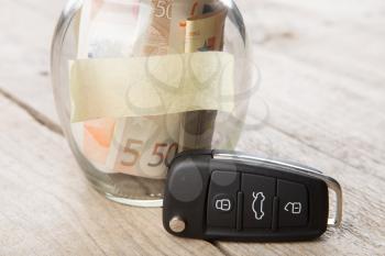 Car finance concept - money glass with sticker, car key