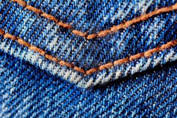 Blue jeans macro. Jeans fabric texture. Seam on jeans.
