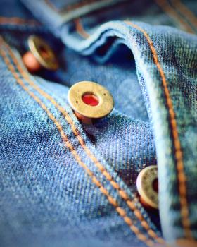 Front piece of the blue jeans. Open buttons fly. Button macro. Jeans button.