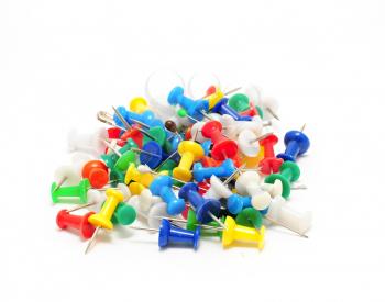 Heap of multicolor office push pins on white background.