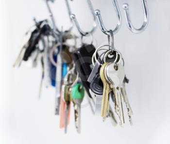 Close up of a bunch of keys hanging on the hooks.