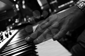 Piano Keyboards In Music Studio And A Hand Of A Musician 